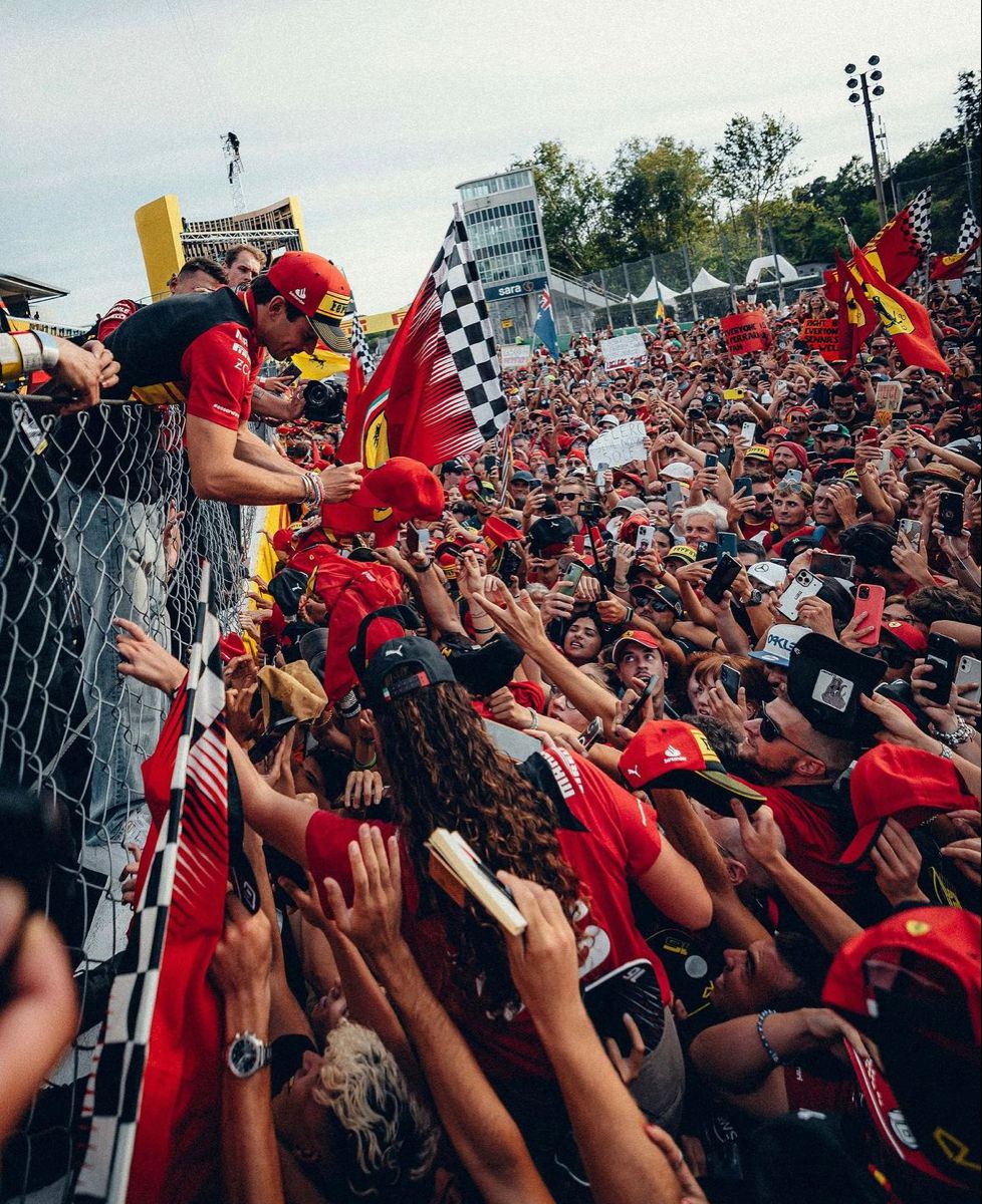 Driver signing autographs in the middle of the Tifosi